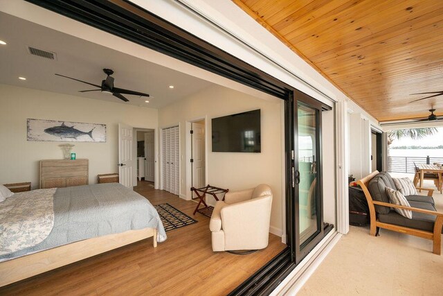 bedroom with hardwood / wood-style flooring, ceiling fan, access to exterior, and wooden ceiling