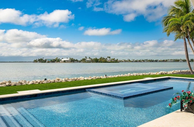 view of swimming pool featuring an in ground hot tub and a water view