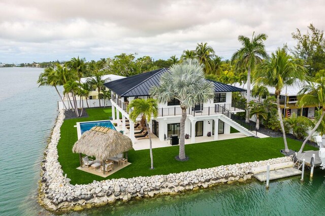 rear view of house with a patio area, a water view, a balcony, a gazebo, and a lawn