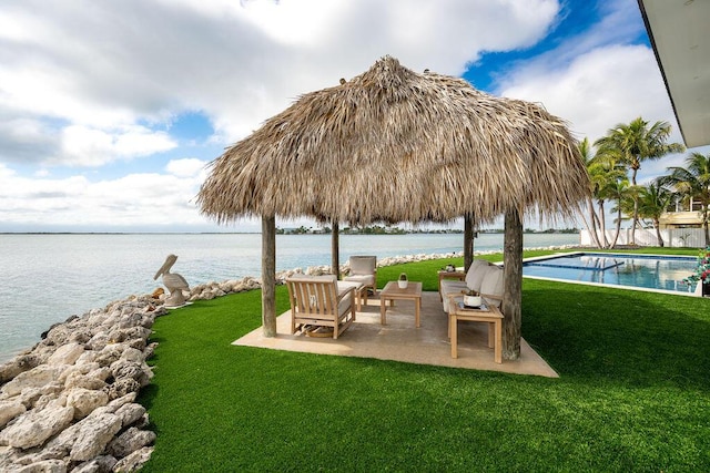 exterior space featuring a patio, a water view, and a gazebo