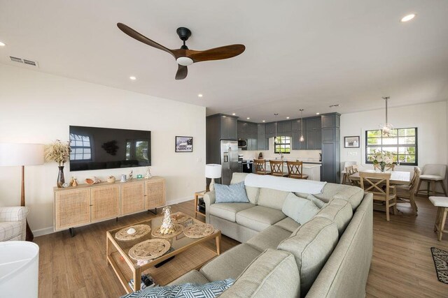 living room featuring dark hardwood / wood-style floors and ceiling fan