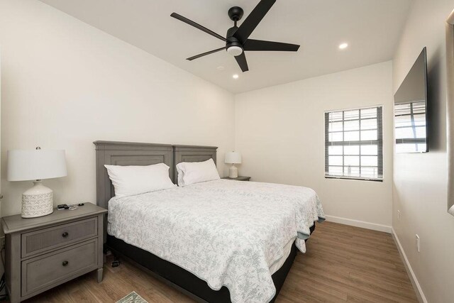 bedroom featuring ceiling fan and dark hardwood / wood-style flooring