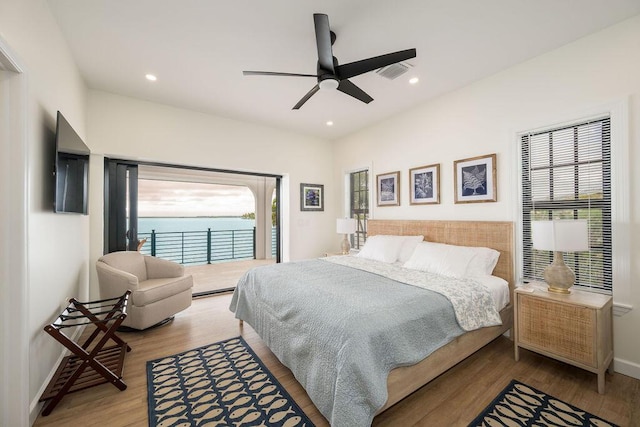 bedroom featuring wood-type flooring, access to outside, and ceiling fan