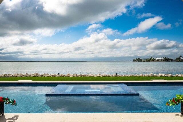 view of swimming pool with a water view