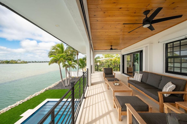 view of patio / terrace featuring an outdoor hangout area, ceiling fan, and a water view