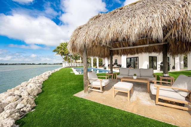 exterior space with a water view, an outdoor hangout area, and a patio area