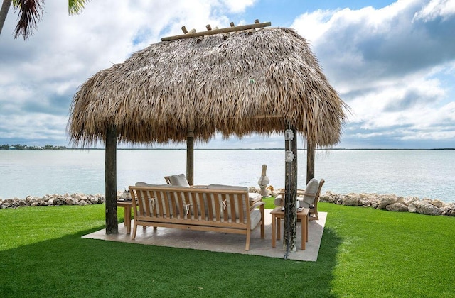 view of dock featuring a water view and a lawn