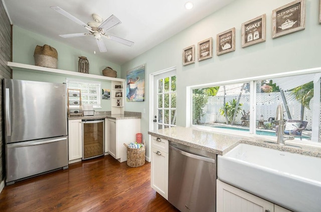 421 United St, Key West, FL 33040 - kitchen with wine cooler, sink, stainless steel appliances, light stone countertops, and white cabinets