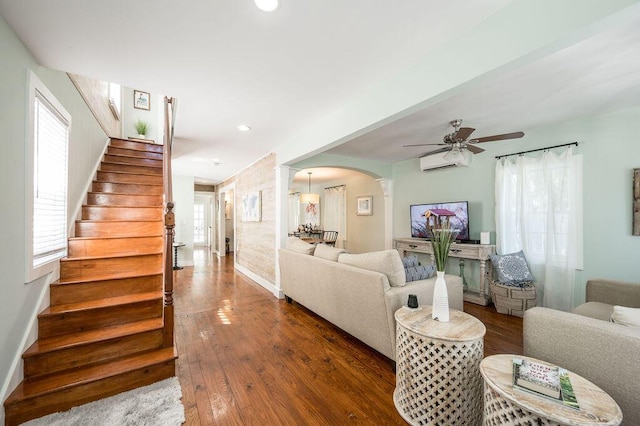 421 United St, Key West, FL 33040 - living room with ceiling fan, dark hardwood / wood-style floors, decorative columns, and a wall unit AC