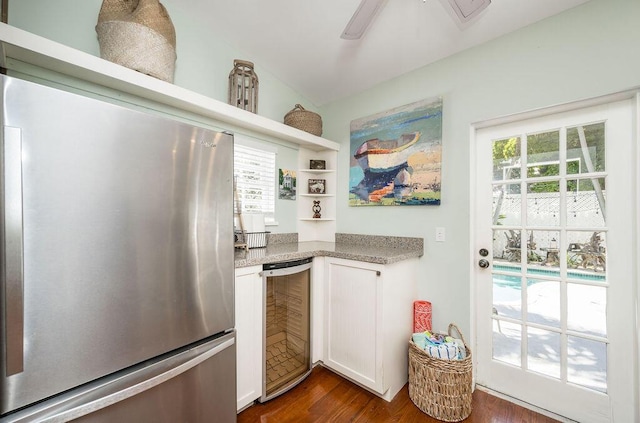 421 United St, Key West, FL 33040 - kitchen with dark wood-type flooring, stainless steel refrigerator, ceiling fan, white cabinets, and beverage cooler