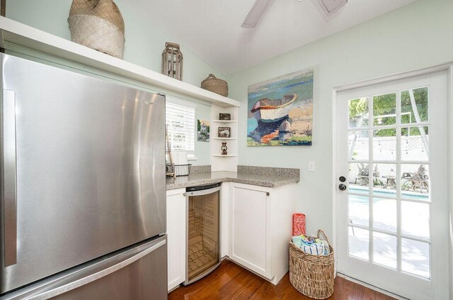 421 United St, Key West, FL 33040 - kitchen featuring wine cooler, dark wood-type flooring, white cabinetry, stainless steel fridge, and ceiling fan