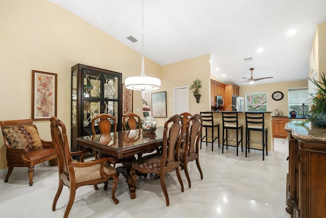 dining room with vaulted ceiling and ceiling fan