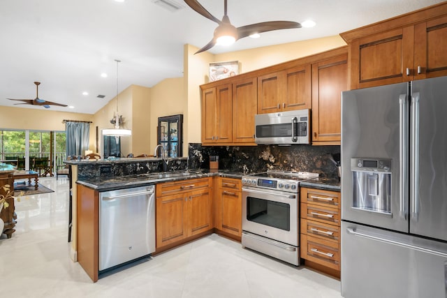 kitchen featuring ceiling fan, appliances with stainless steel finishes, sink, and hanging light fixtures