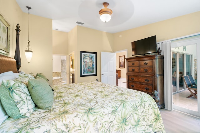 bedroom featuring ceiling fan, access to exterior, and ensuite bath