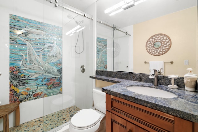 bathroom with vanity, an enclosed shower, and toilet