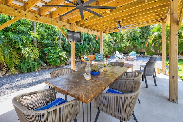 view of patio / terrace with outdoor dining area, a fire pit, and ceiling fan