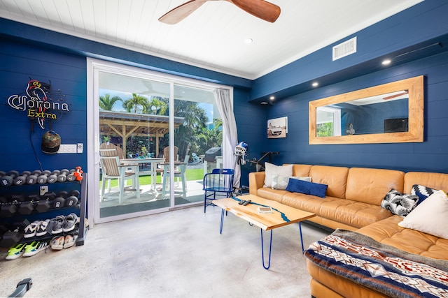 living area featuring visible vents, finished concrete flooring, and a ceiling fan