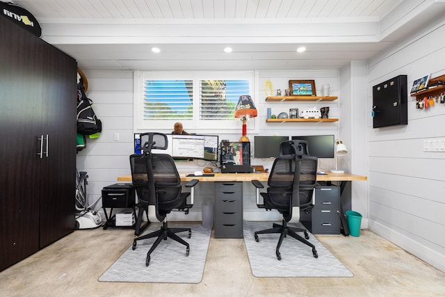 office featuring beam ceiling, wooden walls, recessed lighting, and concrete floors