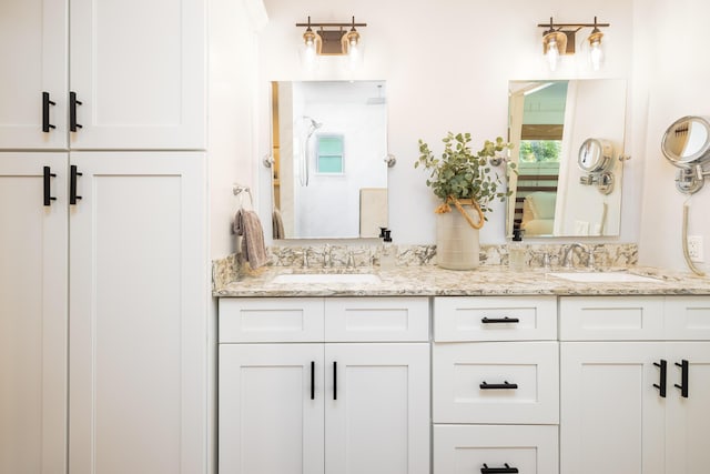 full bathroom featuring a sink, walk in shower, and double vanity