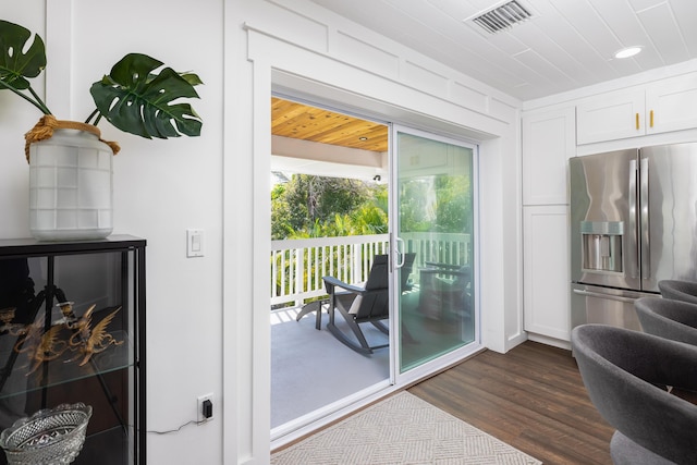 entryway with dark wood-style floors and visible vents