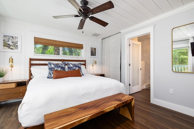 bedroom with visible vents, wood finished floors, baseboards, and ornamental molding