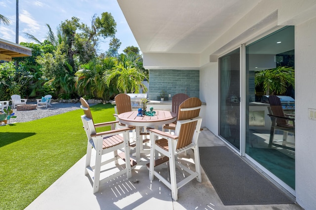 view of patio featuring outdoor dining space and an outdoor fire pit