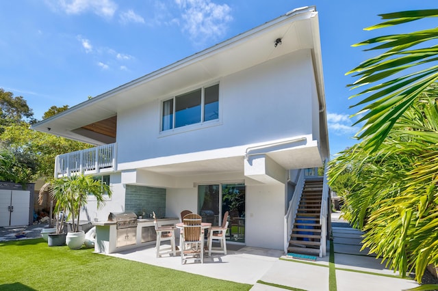 back of property featuring stairway, stucco siding, a yard, a patio area, and area for grilling