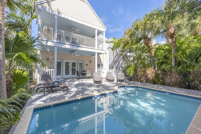 back of property featuring a patio area, a balcony, french doors, and ceiling fan