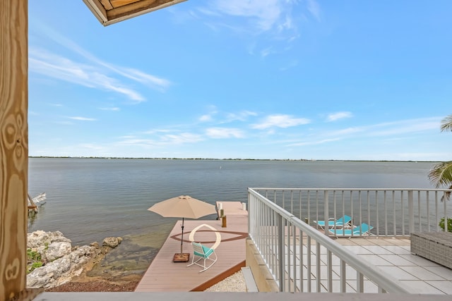 dock area featuring a balcony and a water view