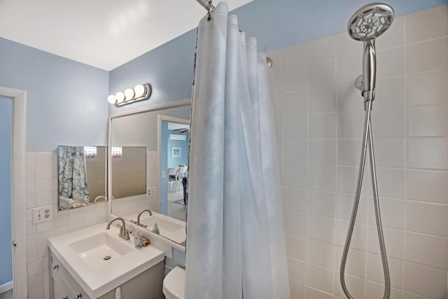 bathroom with vanity, tile walls, curtained shower, and toilet