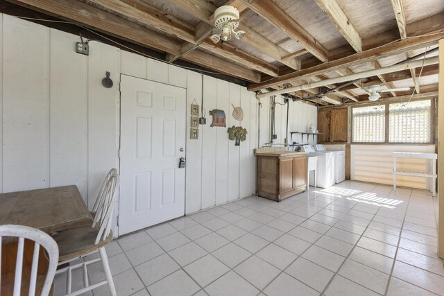 basement with washer and dryer and light tile patterned floors