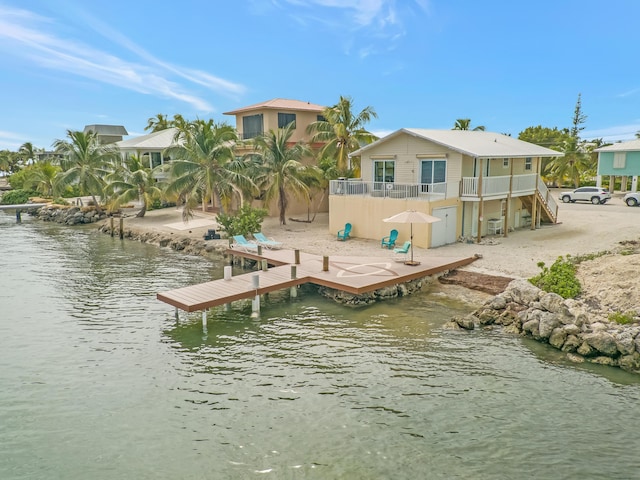 view of dock featuring a water view and a balcony