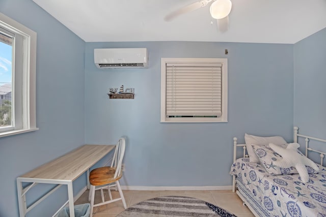 bedroom featuring ceiling fan, light tile patterned floors, and a wall unit AC