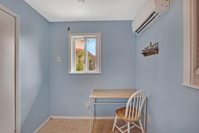 home office with a wall mounted air conditioner, light tile patterned floors, and built in desk