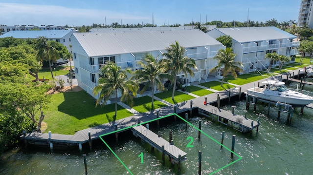95 Coco Plum Dr Unit 1A, Marathon, FL 33050 - dock featuring a yard, a water view, and boat lift
