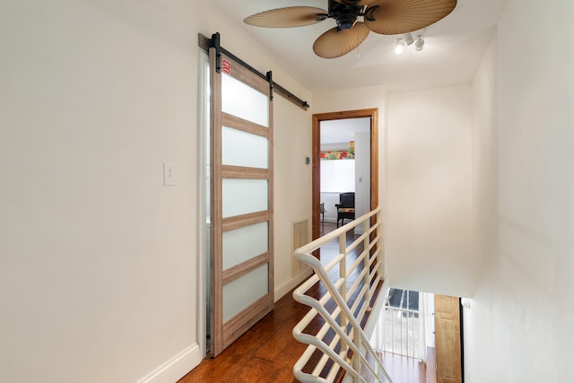 95 Coco Plum Dr Unit 1A, Marathon, FL 33050 - hallway with a barn door, an upstairs landing, and wood finished floors