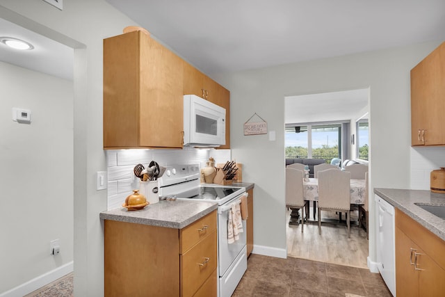 1901 S Roosevelt Blvd Unit 104N, Key West, FL 33040 - kitchen featuring white appliances and decorative backsplash