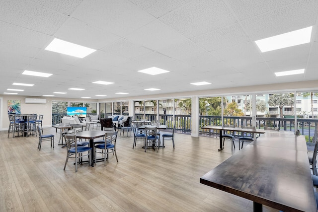 1901 S Roosevelt Blvd Unit 104N, Key West, FL 33040 - dining space with light wood-style floors, a paneled ceiling, and a wall unit AC