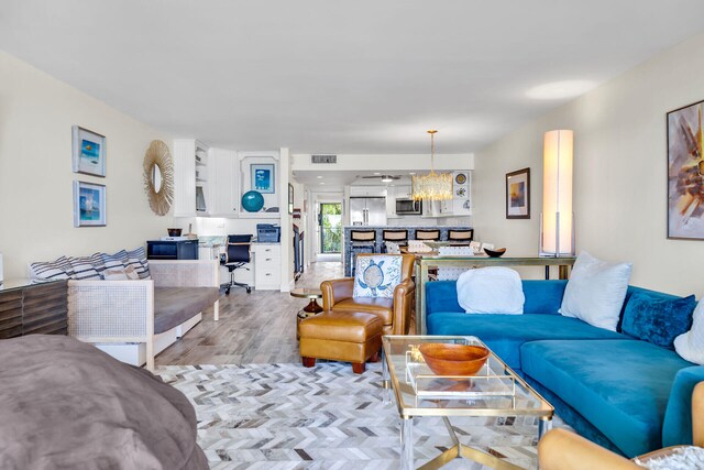 1133 W Ocean Dr Unit 4, Marathon, FL 33050 - living area with wood finished floors and a chandelier