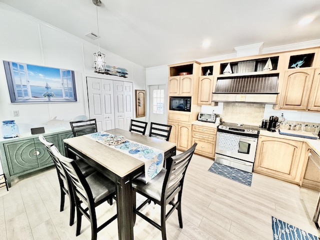 101620 Overseas Hwy Unit 11N, Key Largo, FL 33037 - dining space featuring light wood-style floors, lofted ceiling, and a chandelier