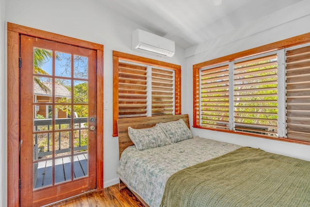 10 W Cook, Big Pine, FL 33043 - bedroom with an AC wall unit and wood finished floors