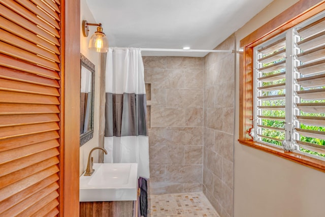 10 W Cook, Big Pine, FL 33043 - bathroom featuring a sink, a tile shower, and a healthy amount of sunlight