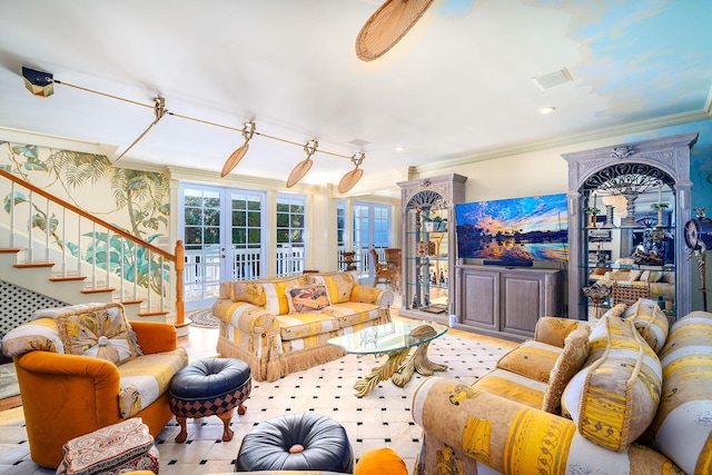 living room with ornamental molding and french doors