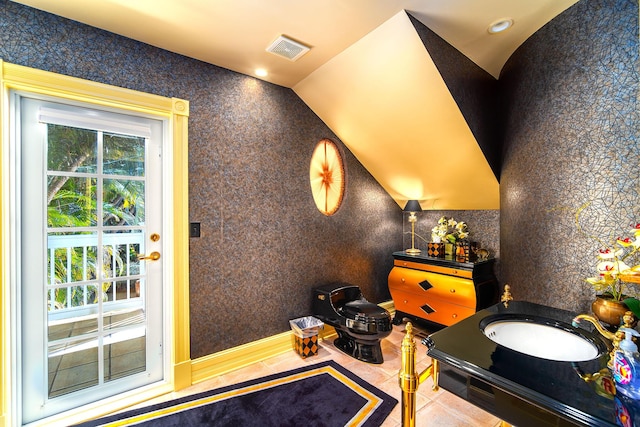 interior space with tile patterned flooring and vaulted ceiling