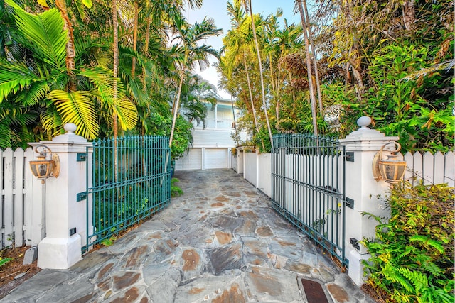 view of gate with a garage