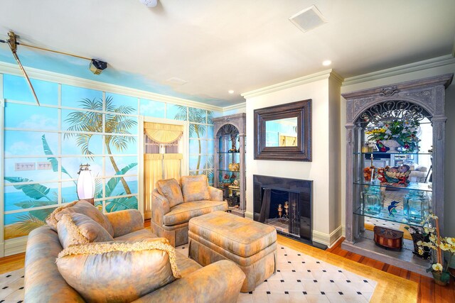 living room featuring crown molding and light hardwood / wood-style floors