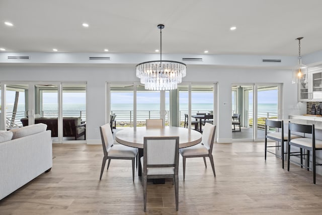 254 W Seaview Cir, Duck, FL 33050 - dining room with recessed lighting, a chandelier, plenty of natural light, light wood finished floors, and a water view