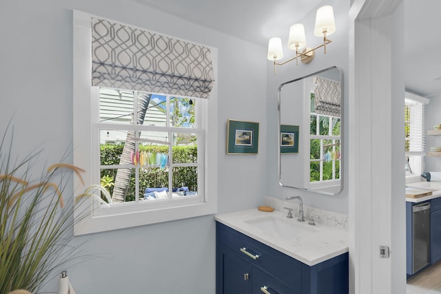 bathroom featuring vanity and a notable chandelier