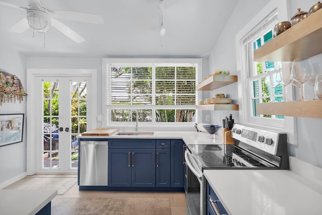 kitchen featuring a sink, stainless steel appliances, blue cabinets, open shelves, and a ceiling fan