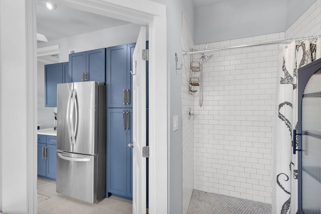 full bath with a shower stall and tile patterned flooring